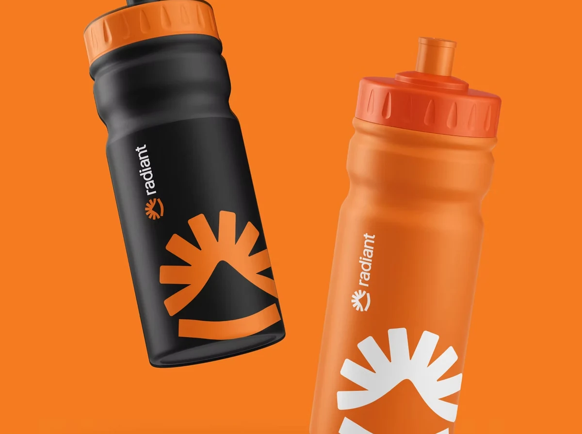 Radiant orange and black bottles showing the complete brand identity